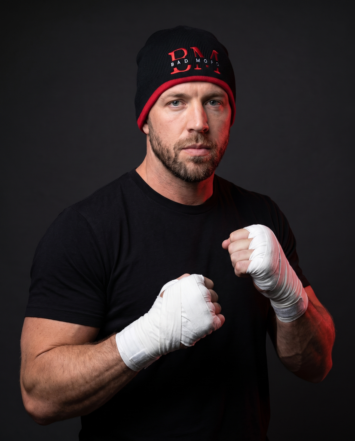 Boxer wearing black BM beanie with red stripe - studio